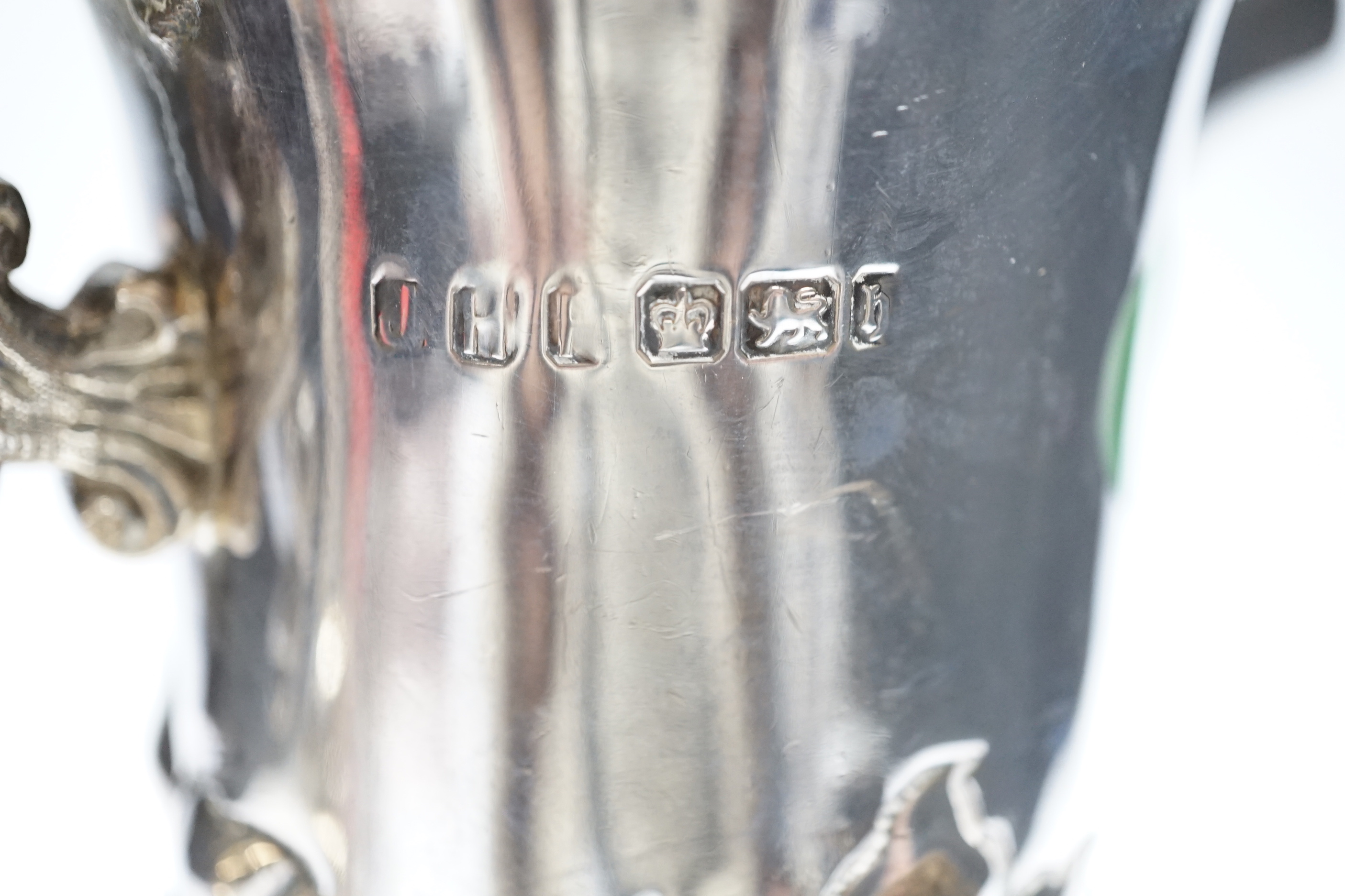 A late Victorian embossed silver jug, John Henry Potter, Sheffield, 1900, height 24.8cm, with replaced plated handle?, gross weight 22.6oz.